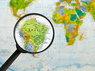 magnifying glass over map of Brazil